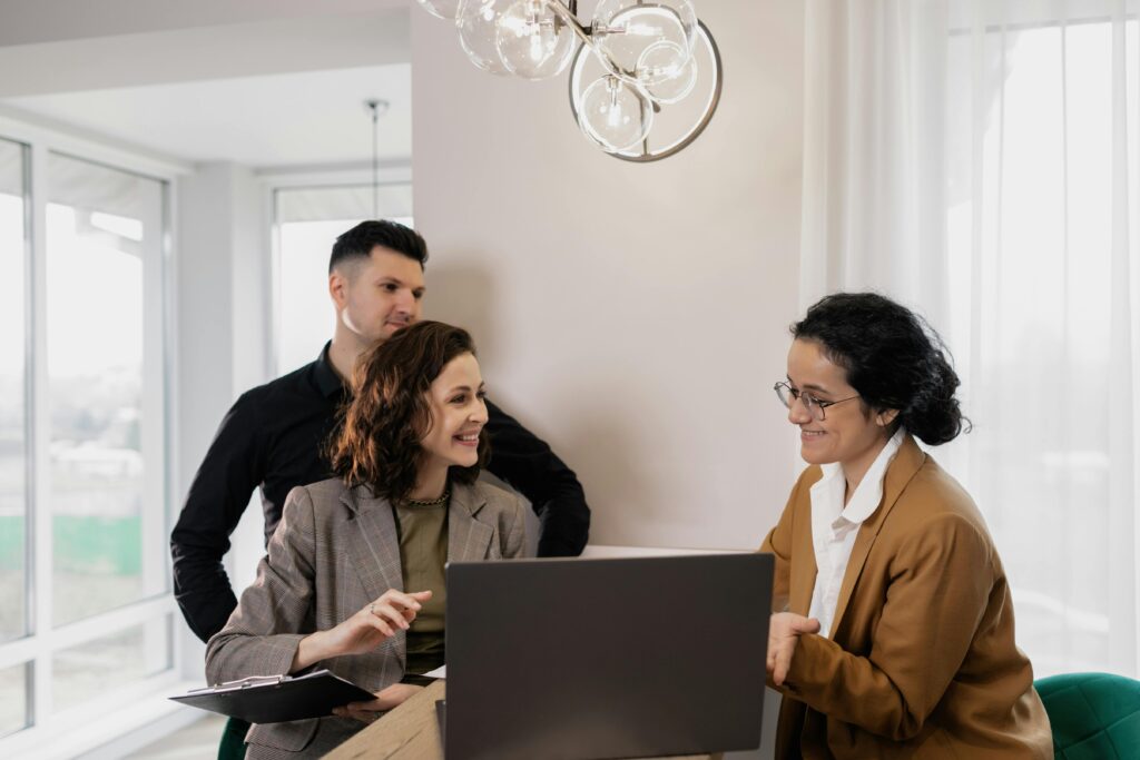 A saleswoman doing face-to-face marketing with her two customers.